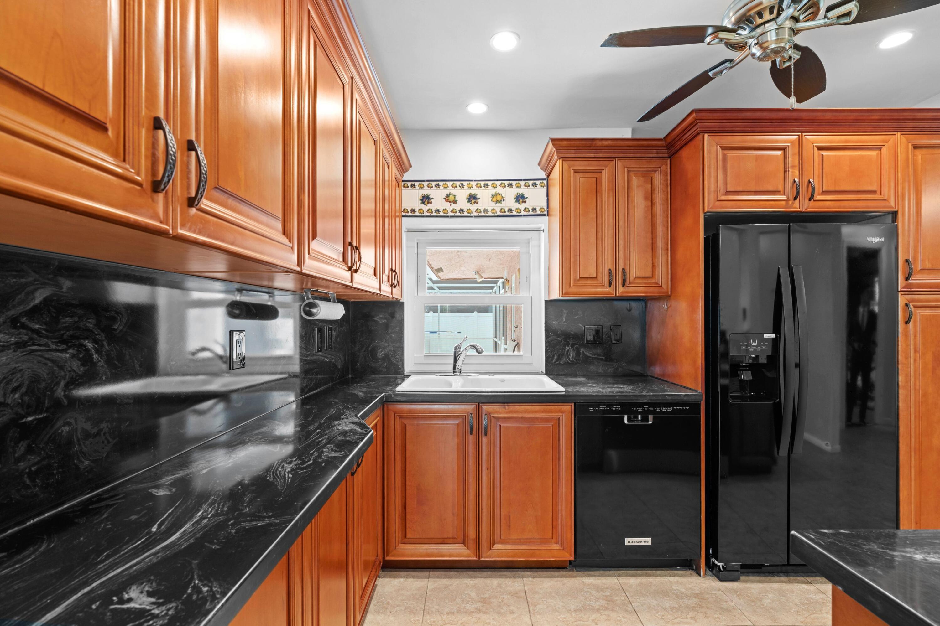 1640 Northwest 10th Street Boca Raton, FL 33486 - Photo 8 of 40 a kitchen with stainless steel appliances granite countertop a refrigerator a stove and a sink