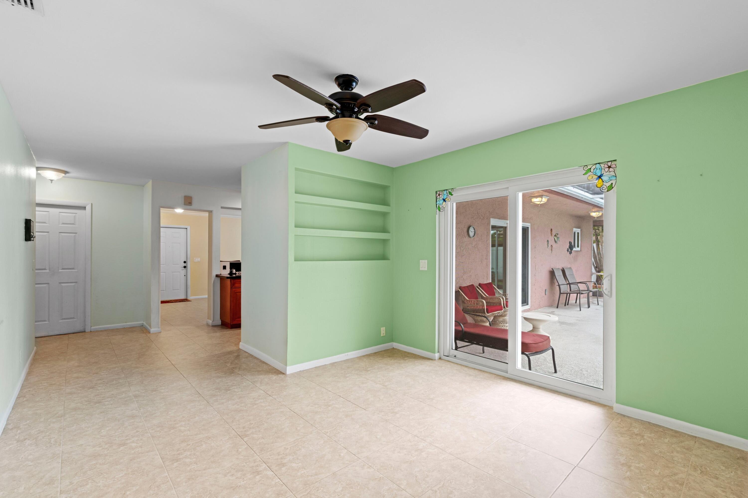 1640 Northwest 10th Street Boca Raton, FL 33486 - Photo 10 of 40 a view of a livingroom with a ceiling fan & entryway