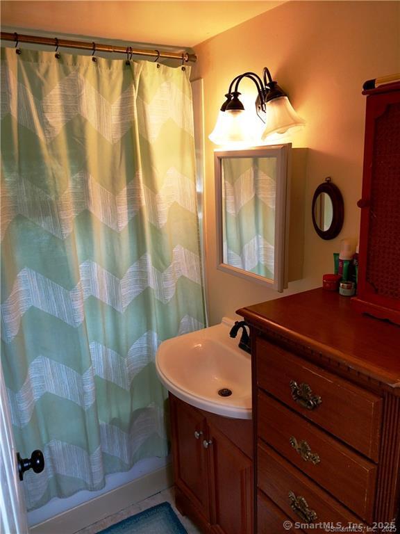 146 Pocono Point Road Danbury, CT 06811 - Photo 7 of 10 a bathroom with a sink and a mirror
