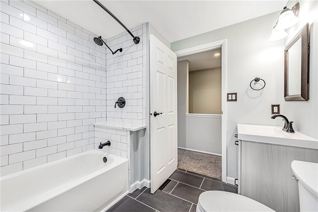 314 Quail Run Road Venetia, PA 15367 - Photo 12 of 24 a bathroom with a sink a toilet a mirror a vanity and shower