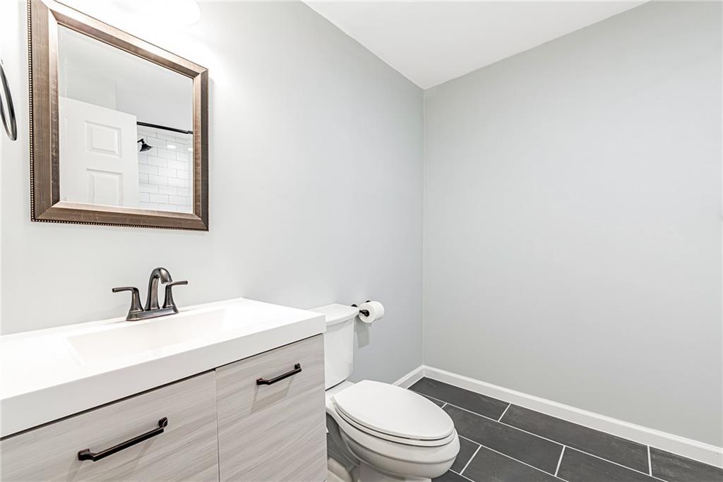 314 Quail Run Road Venetia, PA 15367 - Photo 13 of 24 a bathroom with a toilet a sink and mirror
