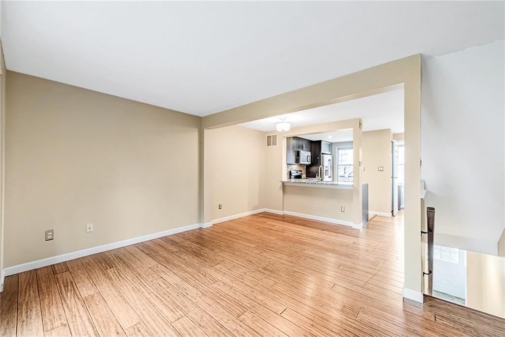 314 Quail Run Road Venetia, PA 15367 - Photo 5 of 24 a view of a big room with wooden floor and kitchen view
