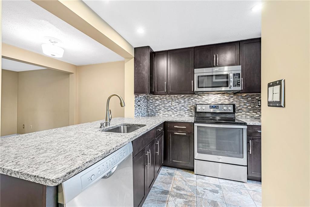 314 Quail Run Road Venetia, PA 15367 - Photo 7 of 24 a kitchen with stainless steel appliances granite countertop a sink stove and microwave