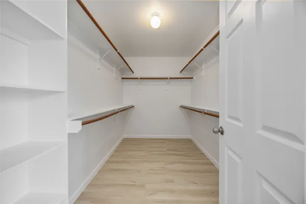 a bathroom with a tub shower and sink