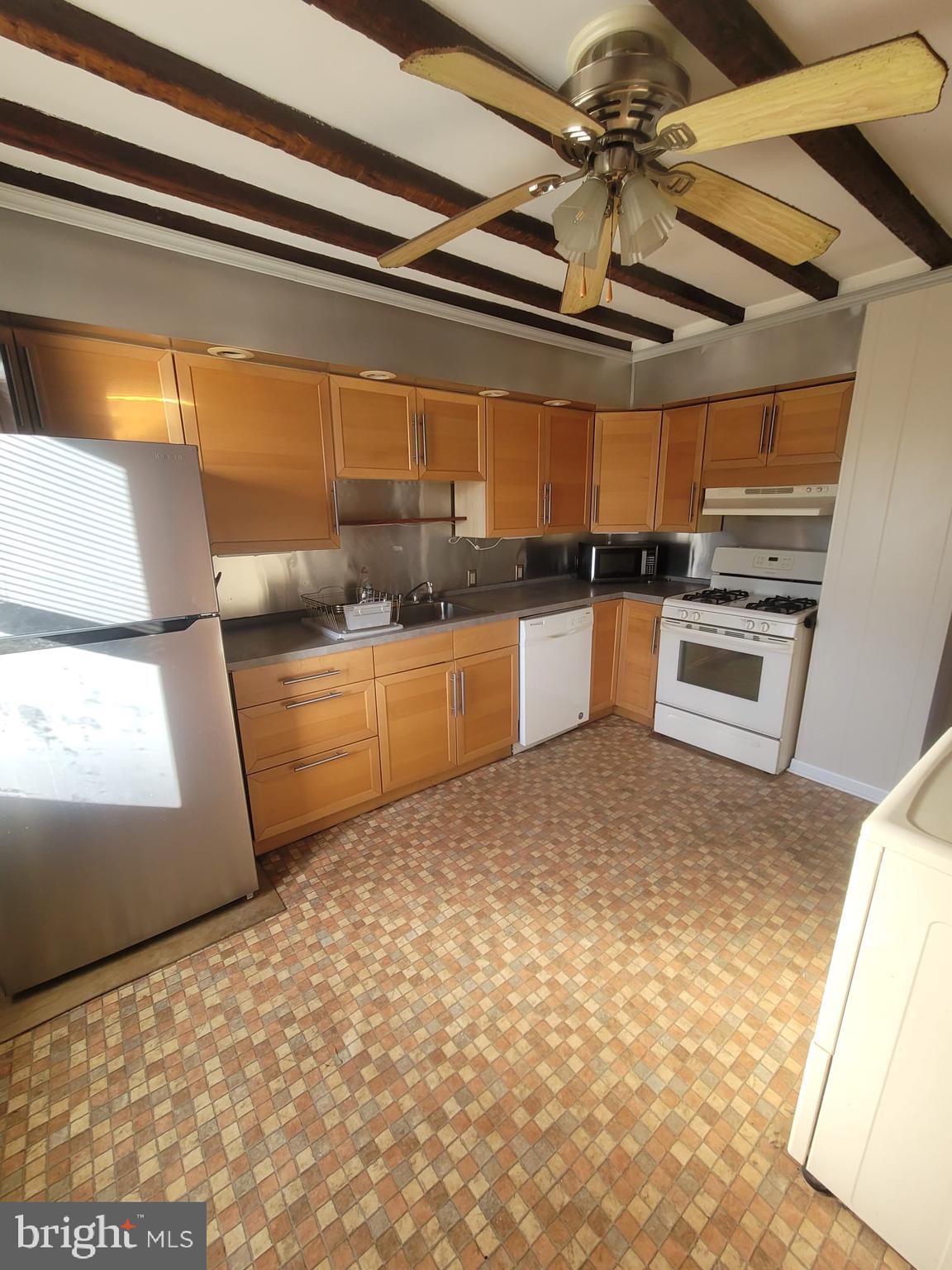 a kitchen with stainless steel appliances granite countertop a sink and cabinets