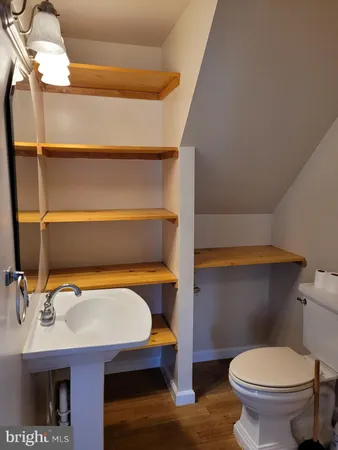 a bathroom with a sink a toilet and a mirror