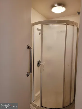 a bathroom with a glass shower door