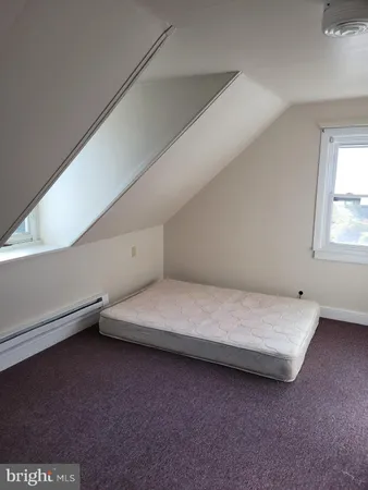 a spacious bedroom with a bed and window