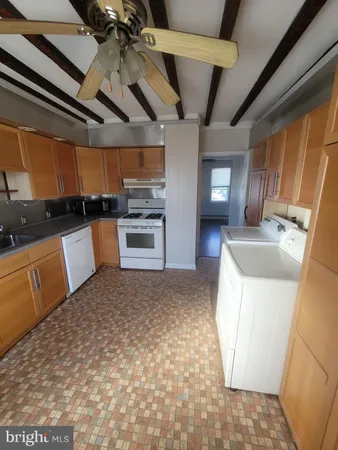 a kitchen with a sink a stove and cabinets