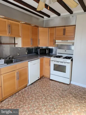 a kitchen with stainless steel appliances granite countertop a stove sink and cabinets