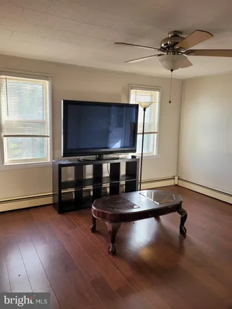 a room with pool table and windows