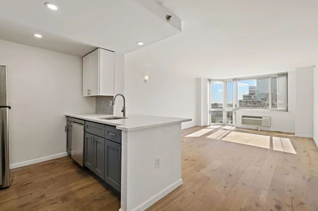 a kitchen with stainless steel appliances granite countertop a stove and a sink