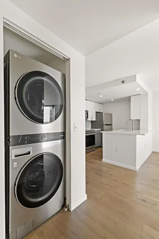a view of a kitchen with a washer and dryer
