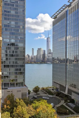 a blue building with swimming pool and lawn chairs