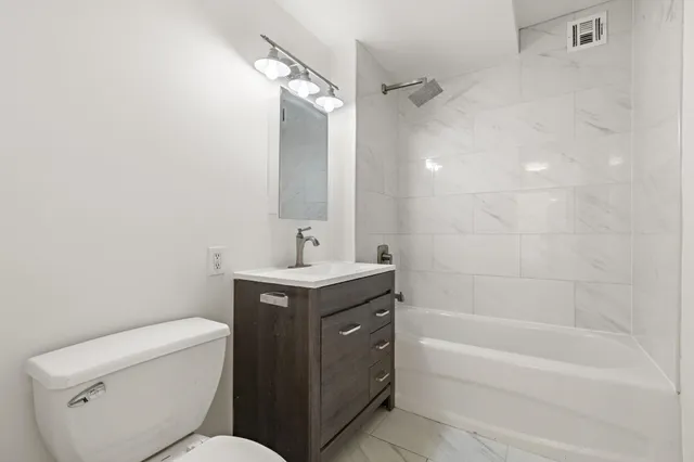 a bathroom with a toilet sink and bathtub