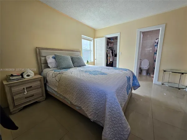 a bed sitting in a bedroom and chair