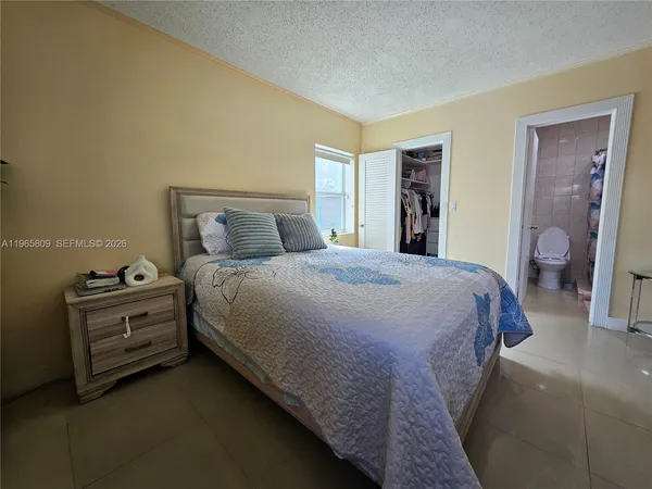 a large bed sitting in a bedroom and closet