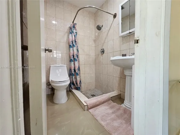 a bathroom with a sink toilet and shower