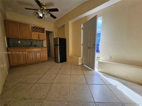 a kitchen with stainless steel appliances a refrigerator and microwave