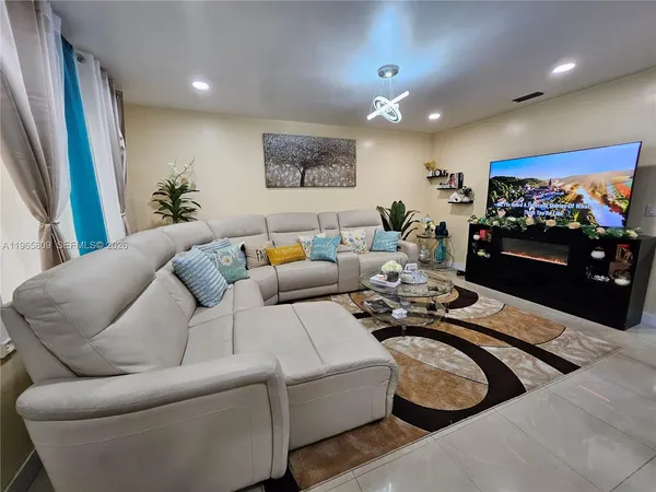 a living room with furniture and a flat screen tv