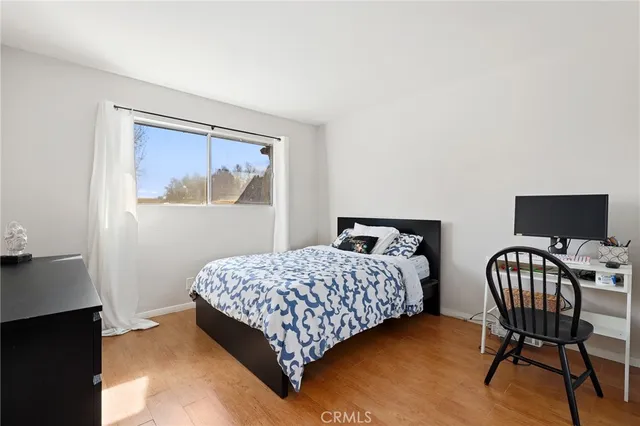 a bedroom with a bed window and a desk