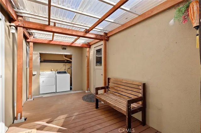 a view of a hallway with a glass door and shower