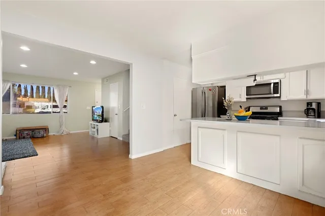 a view of kitchen with sink microwave and refrigerator
