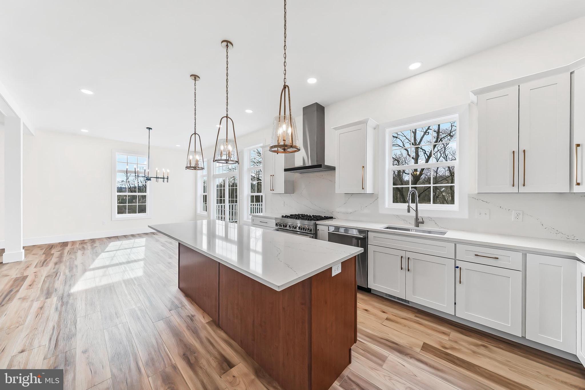 179 Ellicott Road Avondale, PA 19311 - Photo 11 of 65 a large kitchen with stainless steel appliances sink a stove and wooden floor