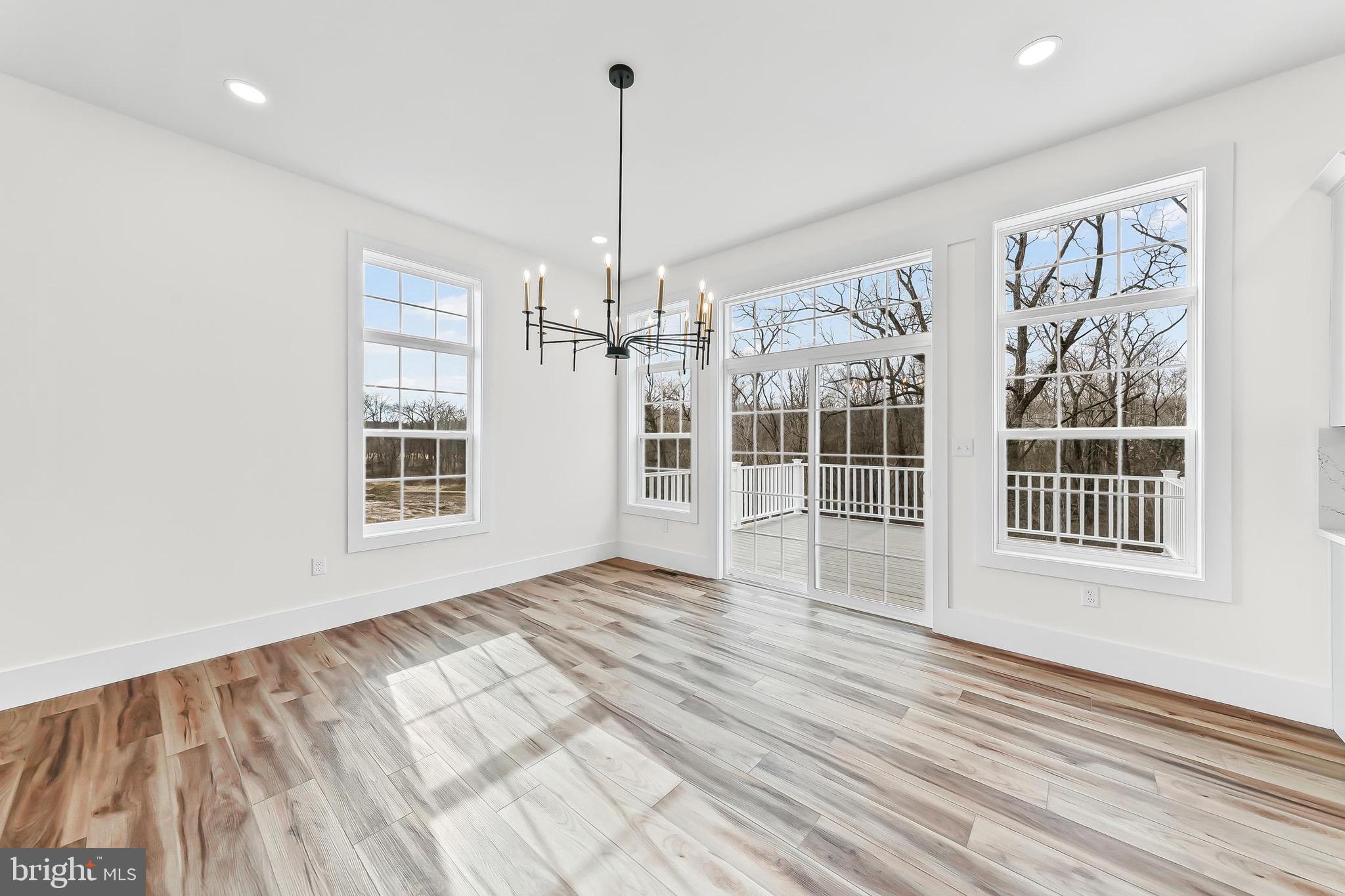 179 Ellicott Road Avondale, PA 19311 - Photo 15 of 65 a view of an empty room with a window and wooden floor
