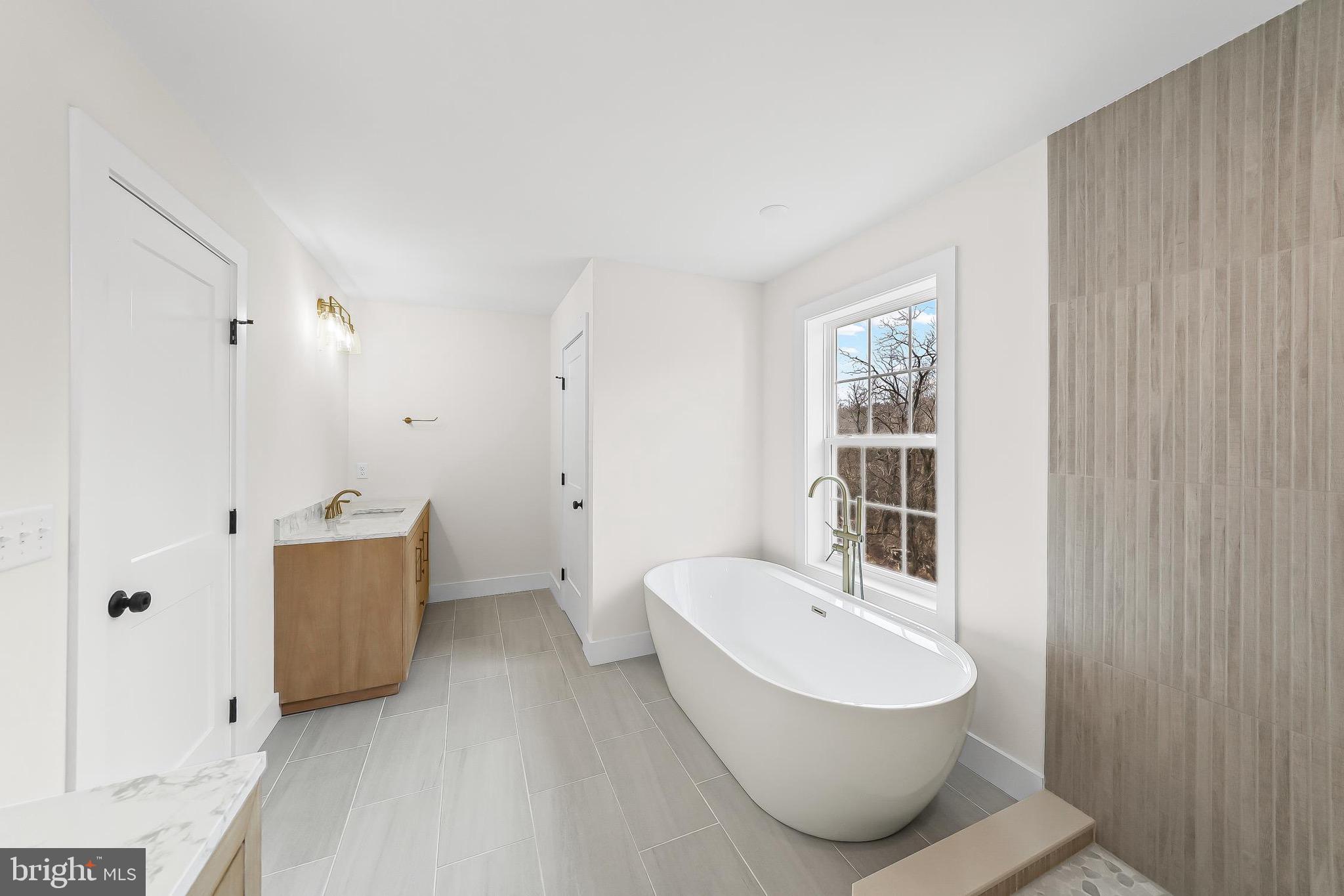 179 Ellicott Road Avondale, PA 19311 - Photo 33 of 65 a bathroom with a tub sink shower and mirror