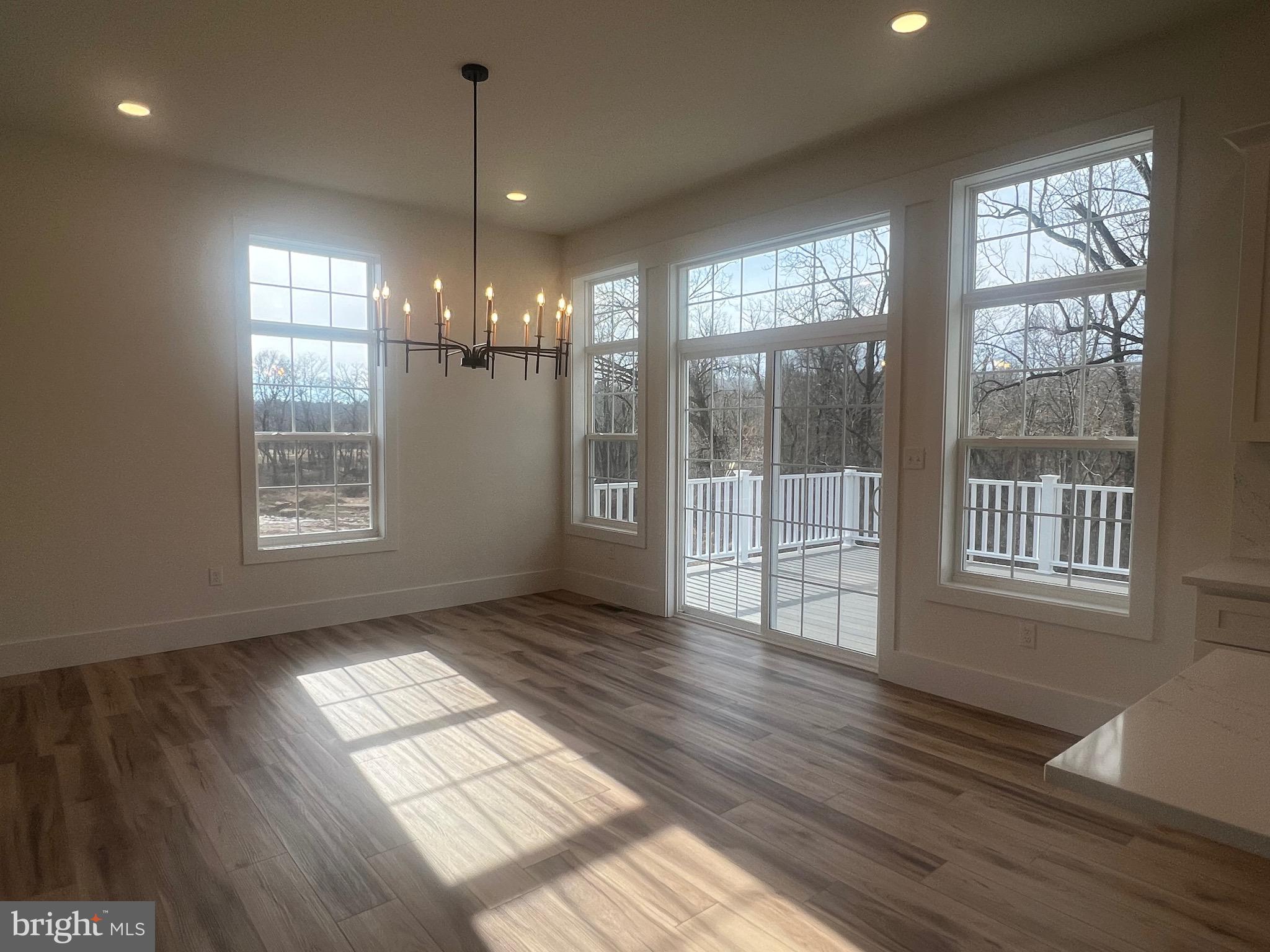 179 Ellicott Road Avondale, PA 19311 - Photo 46 of 65 a view of an empty room with wooden floor and a window