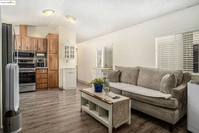 a living room with furniture and a kitchen