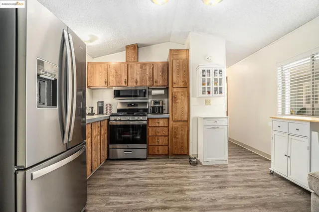 a kitchen with stainless steel appliances a refrigerator sink and cabinets
