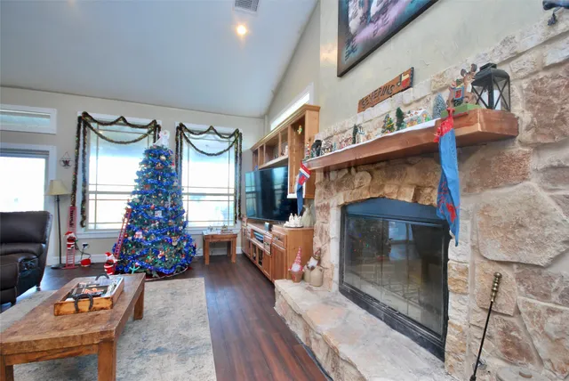 a living room with furniture a chandelier and a flat screen tv
