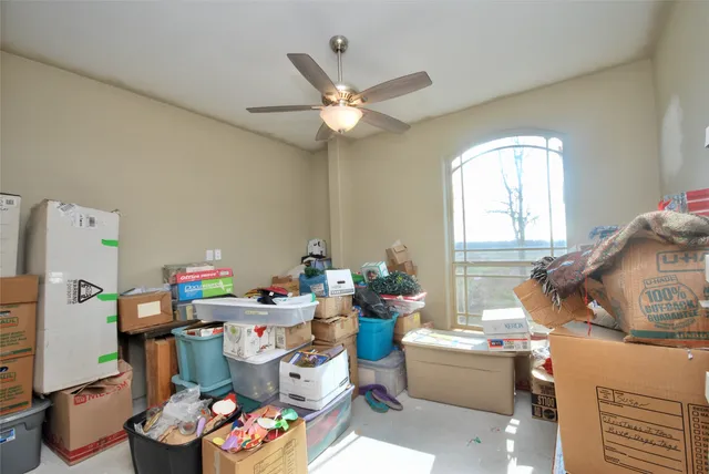 a bedroom with furniture and a large window
