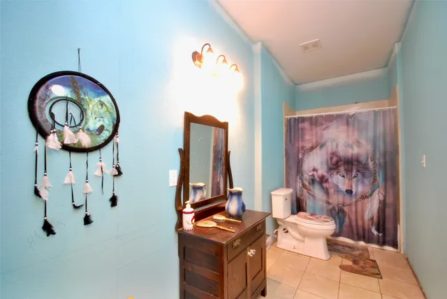 a living room with furniture and a baby crib