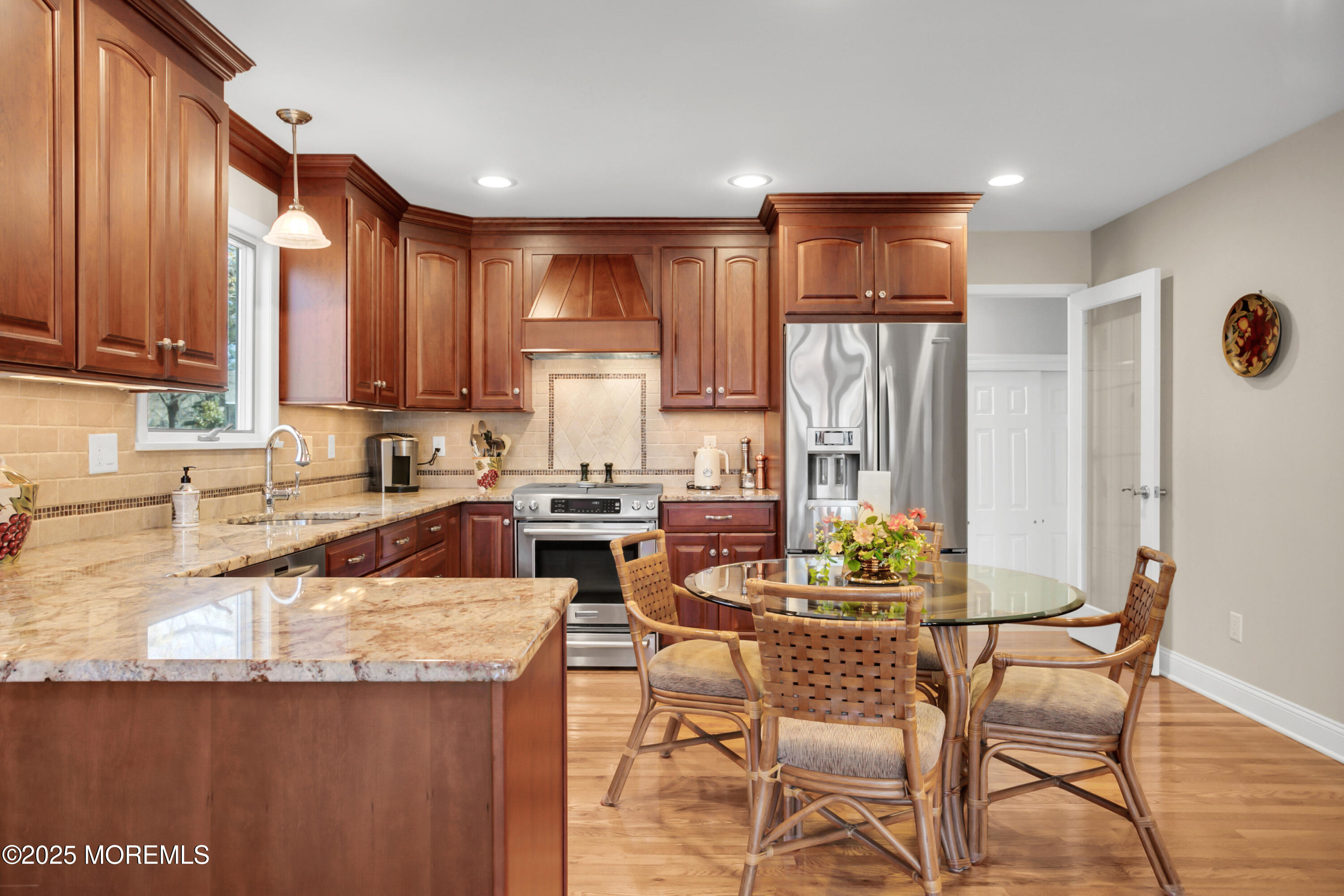 59 Doherty Drive Middletown, NJ 07748 - Photo 19 of 48 a kitchen with granite countertop a table chairs microwave and cabinets