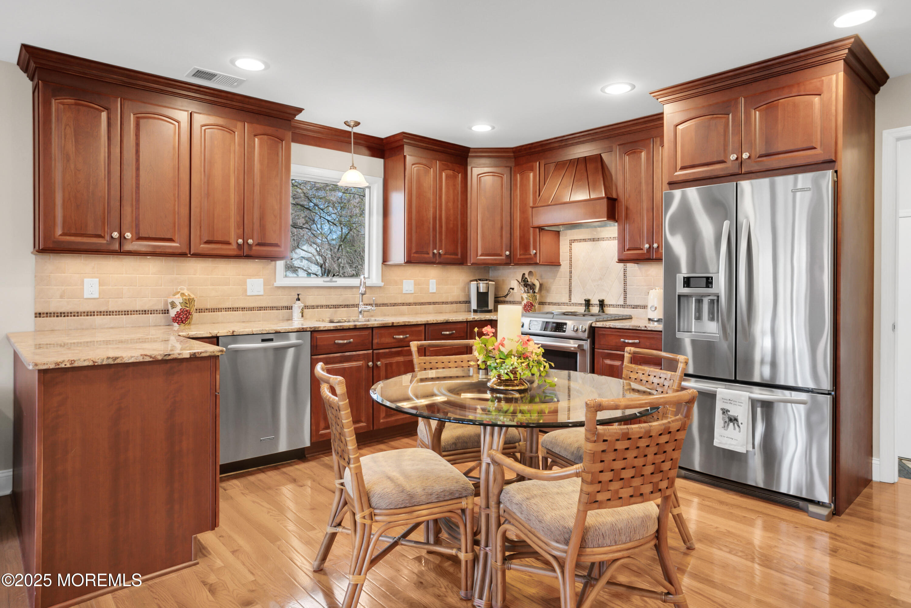 59 Doherty Drive Middletown, NJ 07748 - Photo 20 of 48 a kitchen with stainless steel appliances granite countertop a refrigerator a sink a stove a dining table and chairs