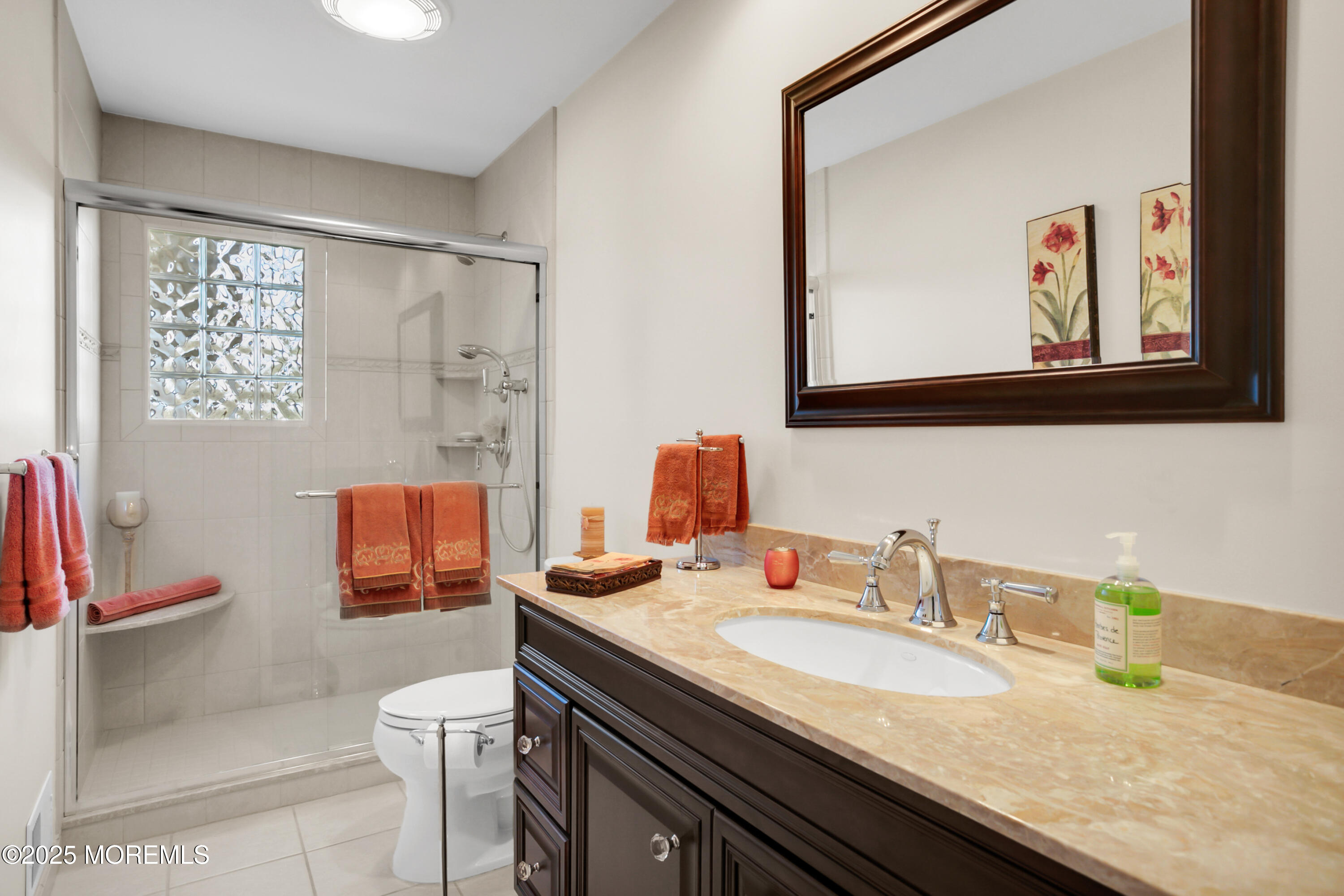 59 Doherty Drive Middletown, NJ 07748 - Photo 25 of 48 a bathroom with a granite countertop sink a mirror and a shower