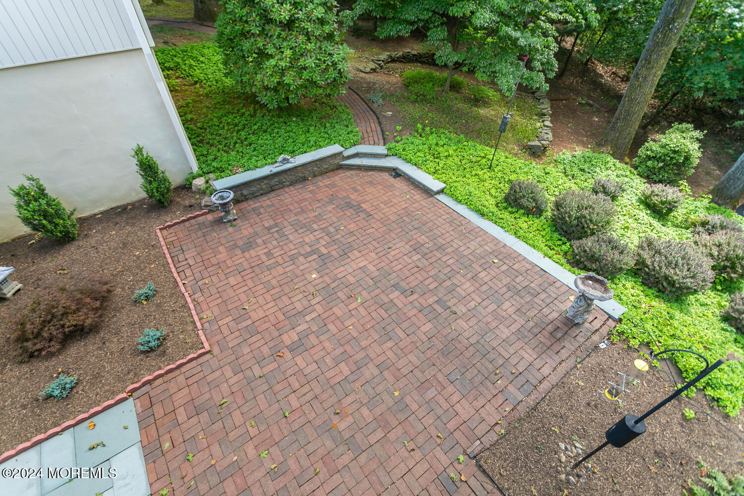 59 Doherty Drive Middletown, NJ 07748 - Photo 41 of 48 a view of a garden with a bench