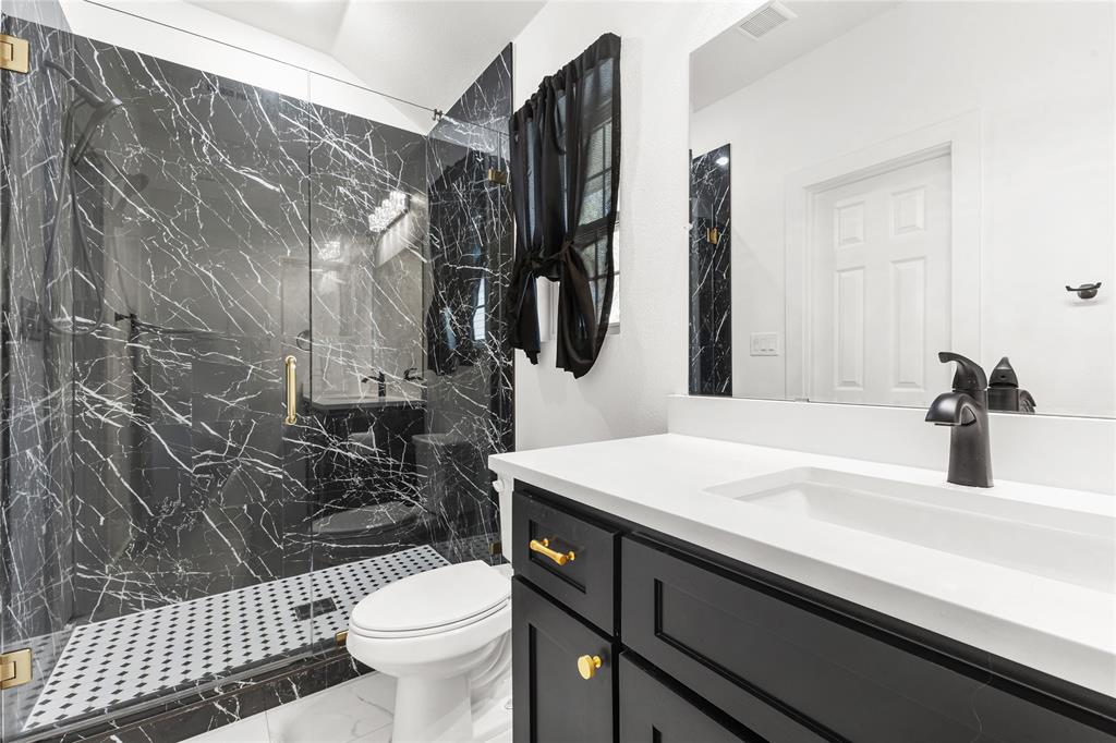 101 Ross Street Sulphur Springs, TX 75482 - Photo 13 of 30 Bathroom with vanity, a marble finish shower, and light marble finish flooring