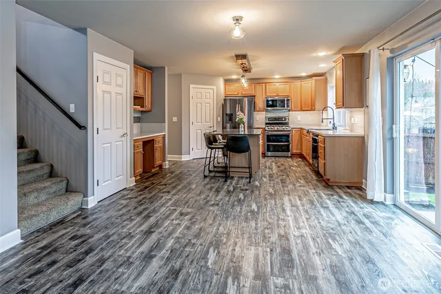 a living room with furniture and kitchen view