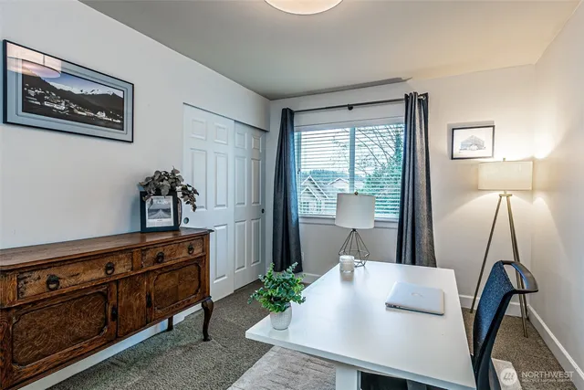 a view of a hallway with furniture and a potted plant