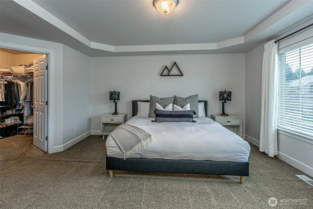 a spacious bedroom with a bed and a window