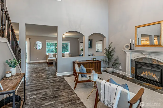 a living room with furniture a fireplace and a potted plant