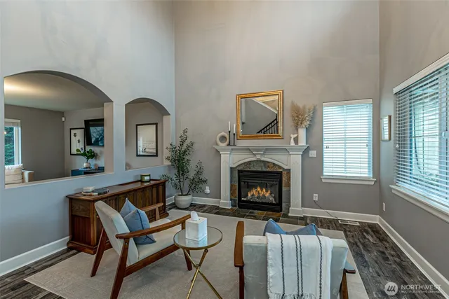 a living room with furniture fireplace and window