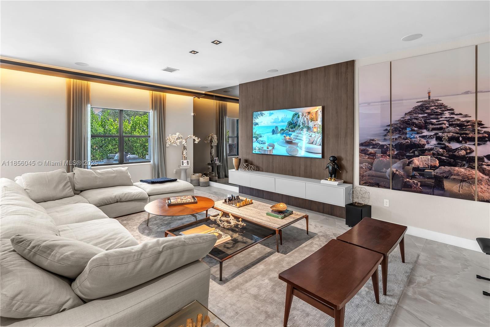 4335 Southwest 173rd Avenue Miramar, FL 33029 - Photo 3 of 59 a living room with furniture a floor to ceiling window and a flat screen tv