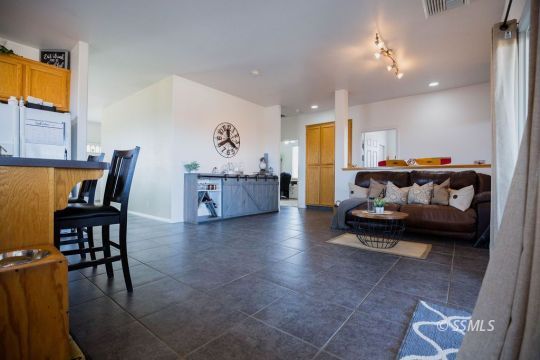 812 South Nevada Street Ridgecrest, CA 93555 - Photo 15 of 34 a living room with furniture and a dining table with wooden floor