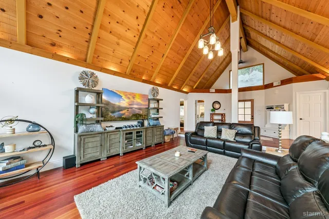 a living room with furniture a rug and a window