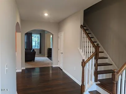 a view of a hallway view with wooden floor and staircase
